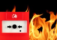 an image of a fire alarm with flames in the background