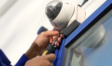 Worker completing a dome camera CCTV installment